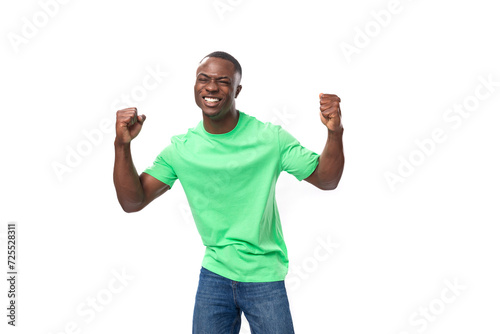 30 year old cool strong african man dressed in light green t-shirt and jeans