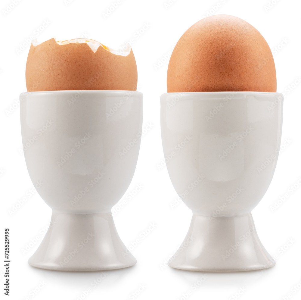Brown soft-boiled chicken eggs in the egg cups isolated on white background. File contains clipping paths. Brown soft-boiled chicken eggs in the egg cups isolated on white background. File contains clipping paths.