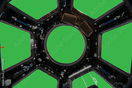 Fototapeta Naklejka Na Ścianę i Meble -  Porthole of space station isolated on green background. Elements of this image furnished by NASA.