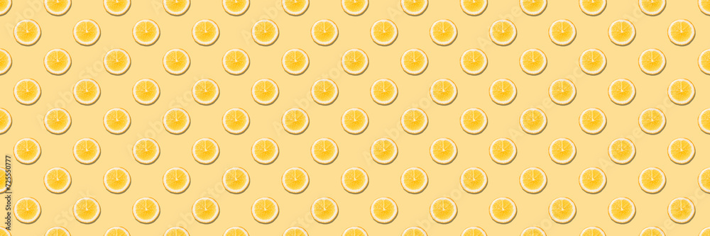 Seamless pattern with round slices of orange on yellow background.