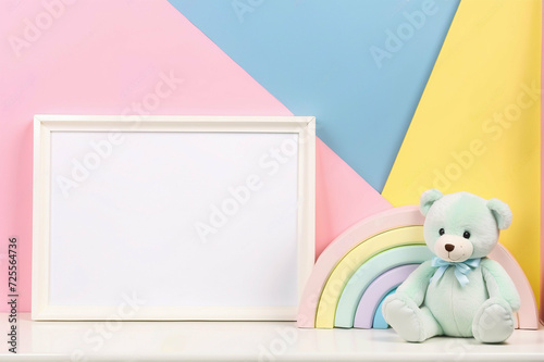 White blank wood frame with teddy bear and pastel toy © Denny