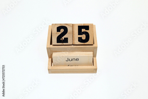 25th of June wooden perpetual calendar. Shot close up isolated on a white background