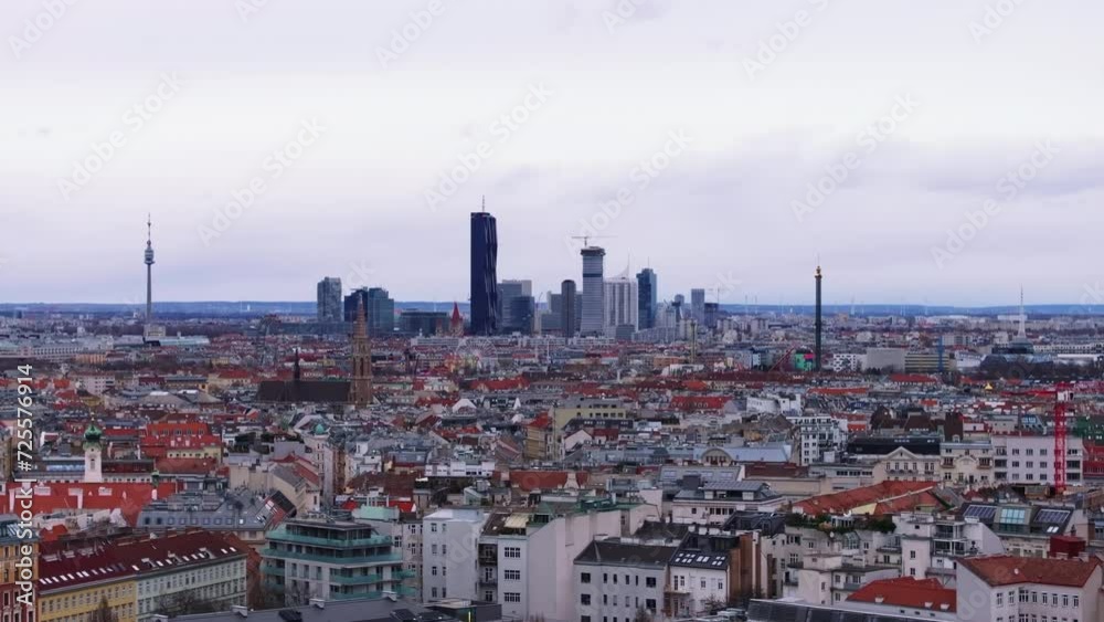 Aerial panoramic view of metropolis. Dense town development in urban boroughs, modern high rise business buildings in distance. Vienna, Austria Aerial panoramic view of metropolis. Dense town development in urban boroughs, modern high rise business buildings in distance. Vienna, Austria