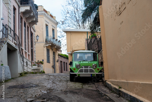 Fototapeta Naklejka Na Ścianę i Meble -  retro house and vintage car on city street in Athens Greece
