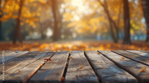 The empty wooden table top with blur background of autumn. Exuberant image.