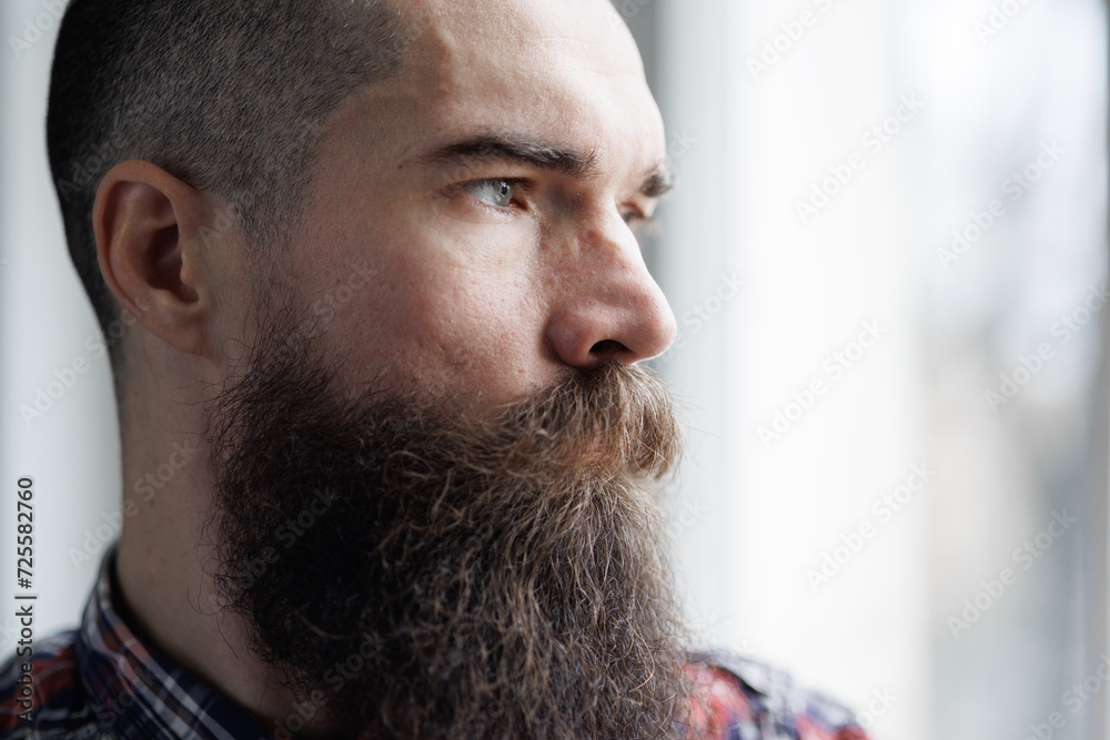 Obraz premium Brutal man with emotion of disappointment and depression on gray background. 