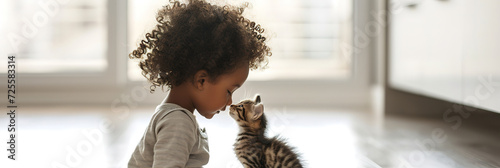 banner little baby girl with joyful expression nose to nose, hugging her tabby kitten in bright, airy home, tender moment of child and domestic pets friendship, lovely owner.