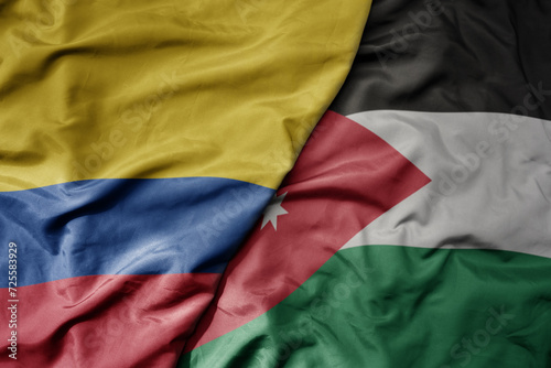 big waving national colorful flag of jordan and national flag of colombia .