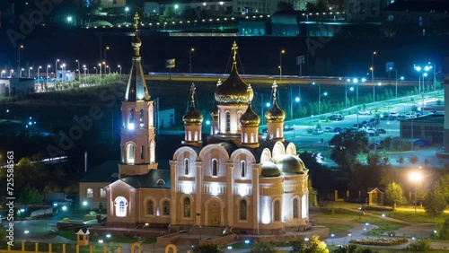 St. Nicholas Cathedral Night Timelapse in Aktobe City. Aerial Top View From Above, Capturing the Spiritual Radiance in the Night Sky of Kazakhstan photo