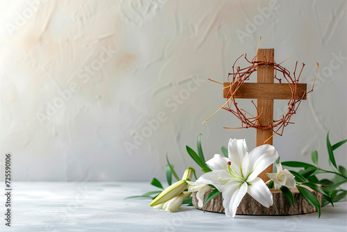 Crown of thorns with wood cross and blossom lilies with copy space. Holy week concept photo