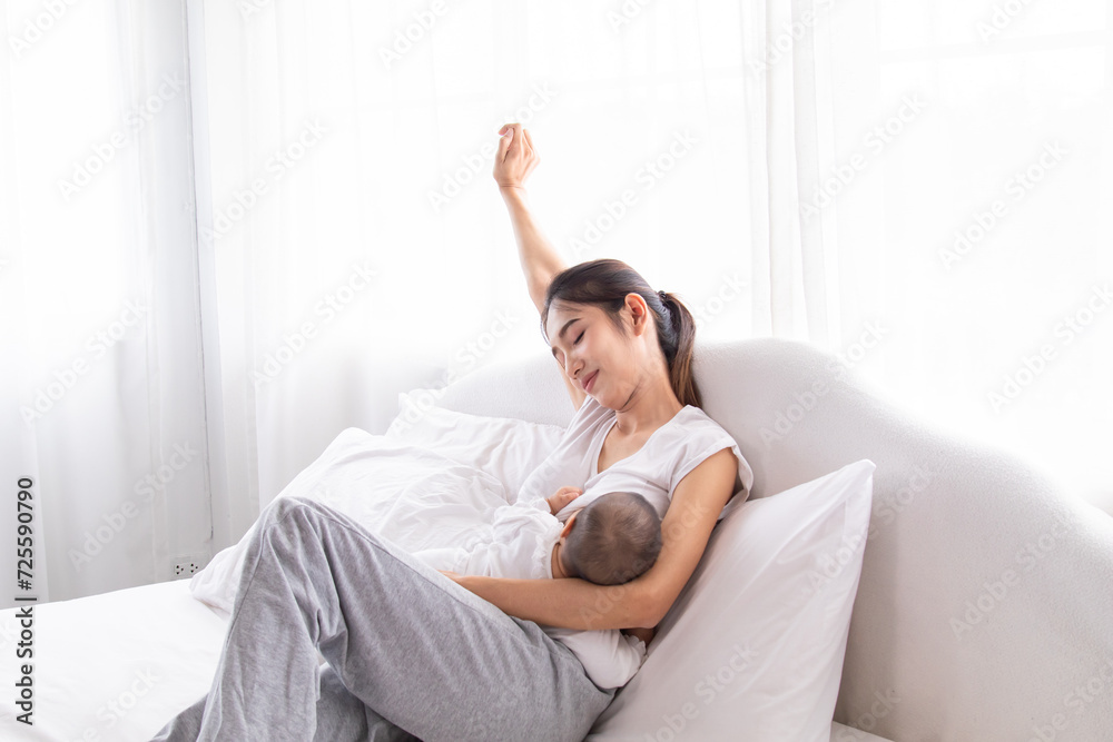 Selective focus young Asian beautiful mother hold newborn baby 0-1 month in her arms with love, gently, infant happy sleeping mom looking infant , newborn baby feeling secure while sleeping in mom arm Selective focus young Asian beautiful mother hold newborn baby 0-1 month in her arms with love, gently, infant happy sleeping mom looking infant , newborn baby feeling secure while sleeping in mom arm