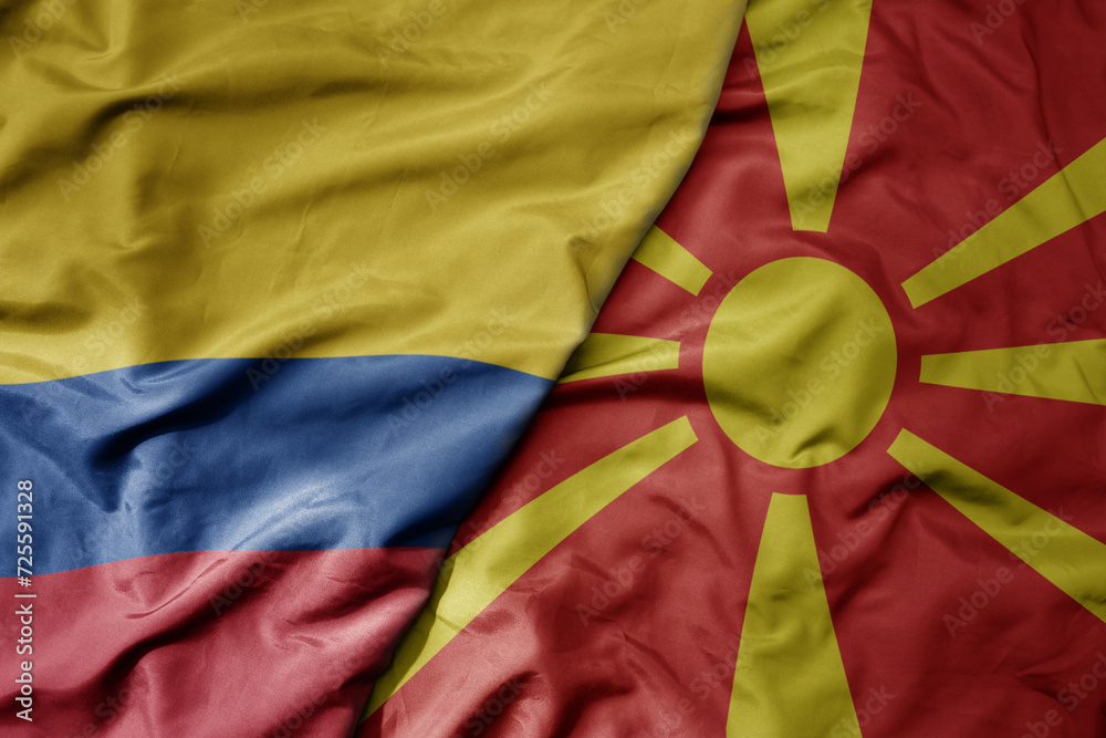 big waving national colorful flag of macedonia and national flag of colombia .