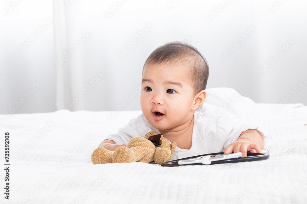 Closeup shot of toddler newborn baby wearing bodysuit leisure soft touch comfortable lying down alone on bed and looking camera at home, healthcare and pediatrics. Baby health care products concept. Closeup shot of toddler newborn baby wearing bodysuit leisure soft touch comfortable lying down alone on bed and looking camera at home, healthcare and pediatrics. Baby health care products concept.