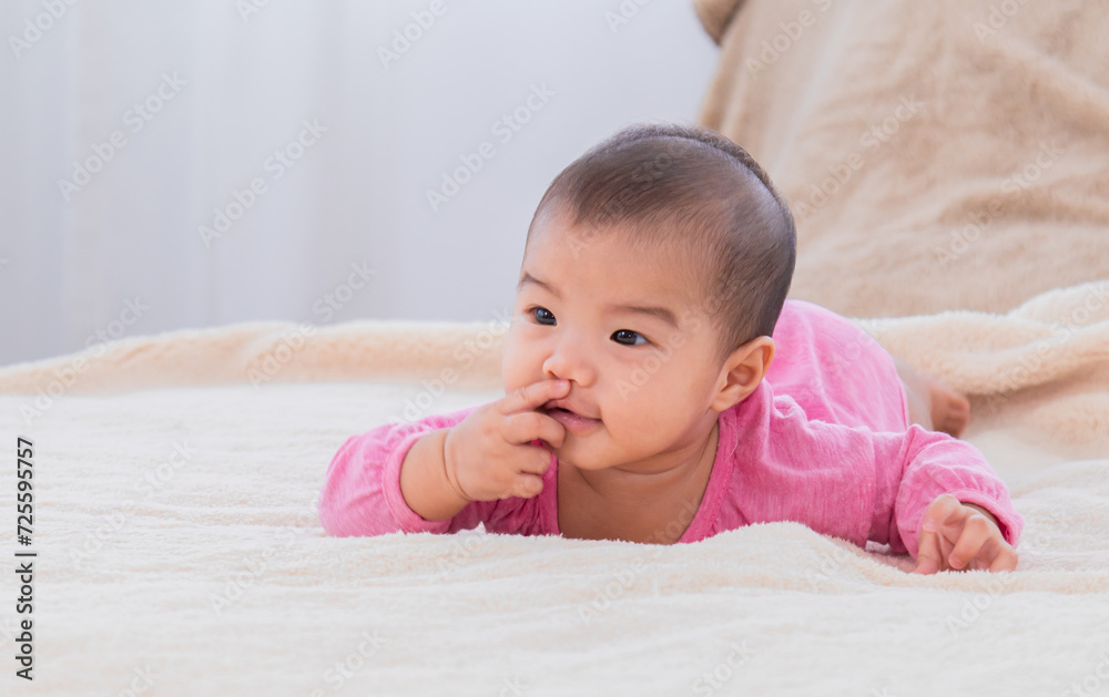 Closeup shot of toddler newborn baby wearing bodysuit leisure soft touch comfortable lying down alone on bed and looking camera at home, healthcare and pediatrics. Baby health care products concept. Closeup shot of toddler newborn baby wearing bodysuit leisure soft touch comfortable lying down alone on bed and looking camera at home, healthcare and pediatrics. Baby health care products concept.