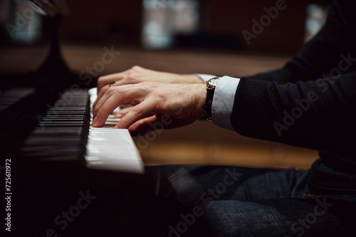 Male hands playing piano