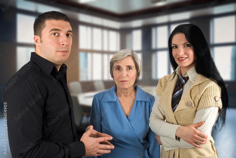Three people dressed casually in the conference room Three people dressed casually in the conference room