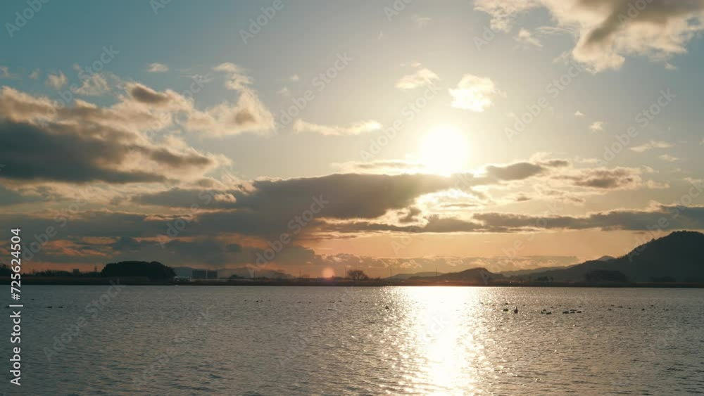 Colorful sunset over calm lake water surface Colorful sunset over calm lake water surface
