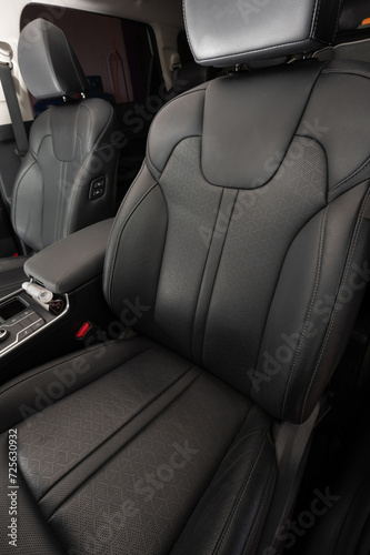 Clean black leather car chair © PixieMe