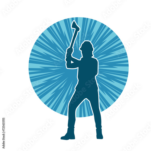 Silhouette of a worker in action pose using his axe tool.