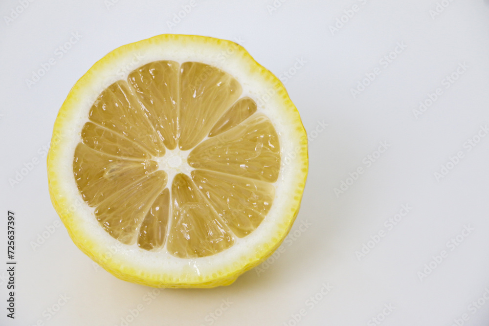 Close-up of a sliced lemon piece displaying its juicy inner texture and cross section pattern, lemons are citrus fruits known for their sour taste and many health benefits Close-up of a sliced lemon piece displaying its juicy inner texture and cross section pattern, lemons are citrus fruits known for their sour taste and many health benefits