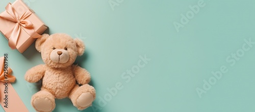 Teddy bear on pastel turquoise background. Flat lay, top view.