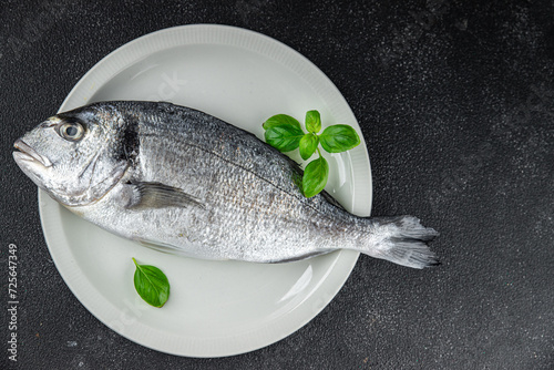 sea bream fish raw seafood tasty fresh healthy eating cooking appetizer meal food snack on the table copy space food background rustic keto or paleo diet Pescetarian