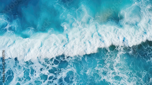 Aerial view of blue ocean wave. Top view of turquoise water with foam .
