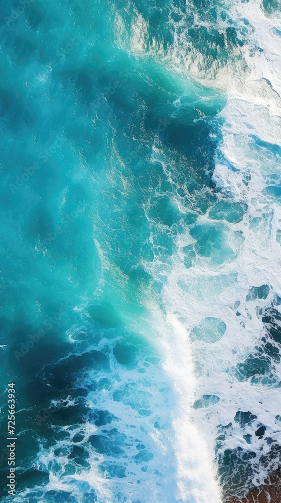 Aerial view of ocean waves crashing on the shore. Top view