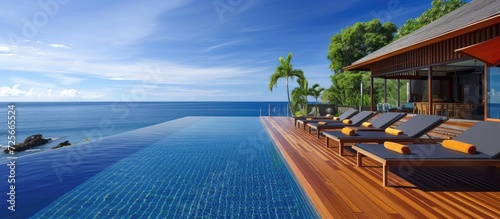 Covered outdoor pool with teak deck and exotic flooring stripes around the blue water. © Vusal