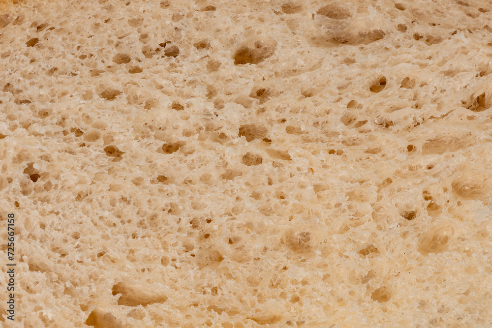 Macro closeup of a slice of loaf of freshly baked sourdough bread