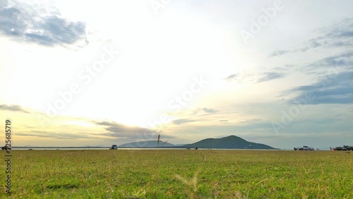 sunset over the river and grass.