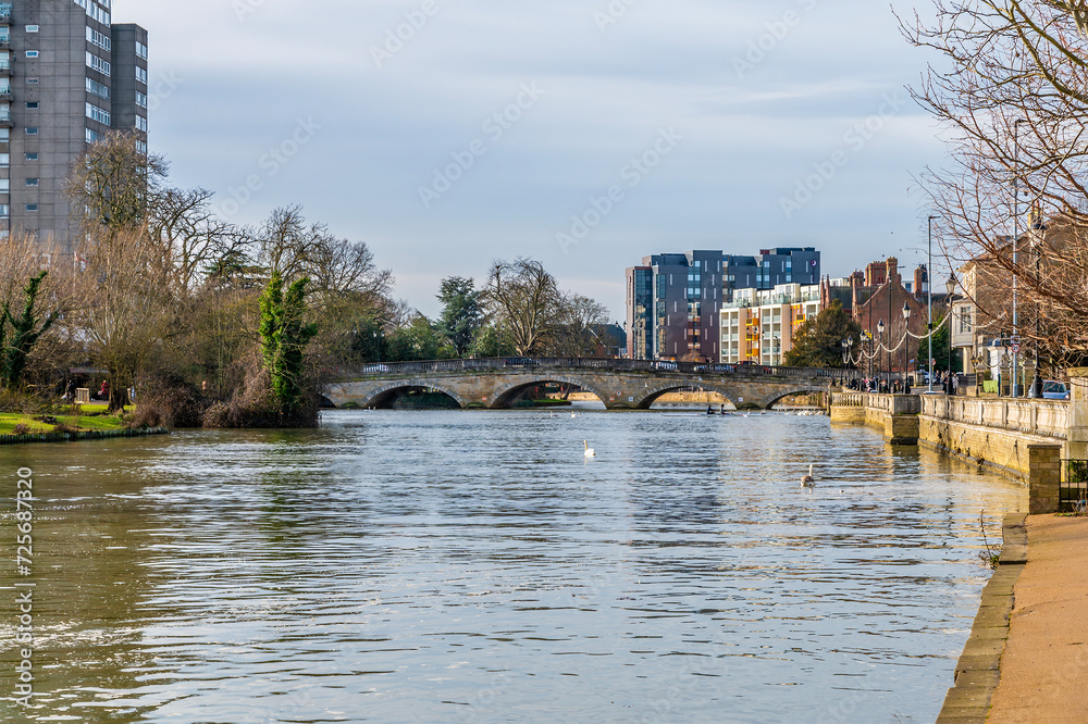 A view from the Embankment down the River Great Ouse towards the town bridge in Bedford, UK on a bright sunny day