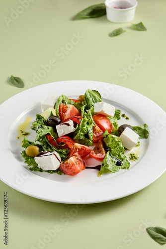 Classic Greek Salad with Feta Cheese and Fresh Vegetables on White Plate