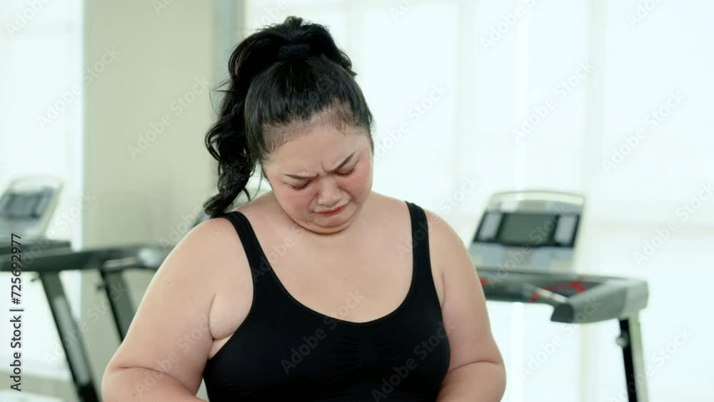 The disappointed face of chubby girl After using tape measure to measure your waist circumference. Unable to lose weight to make the waist smaller After exercising, run on treadmill to lose weight. The disappointed face of chubby girl After using tape measure to measure your waist circumference. Unable to lose weight to make the waist smaller After exercising, run on treadmill to lose weight.