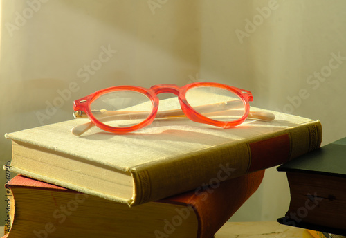 New book releases for spring and summer, with stack of books, spectacles and sun light.Spring Book fair, inspiration,reading, education, literature concept, free copy space