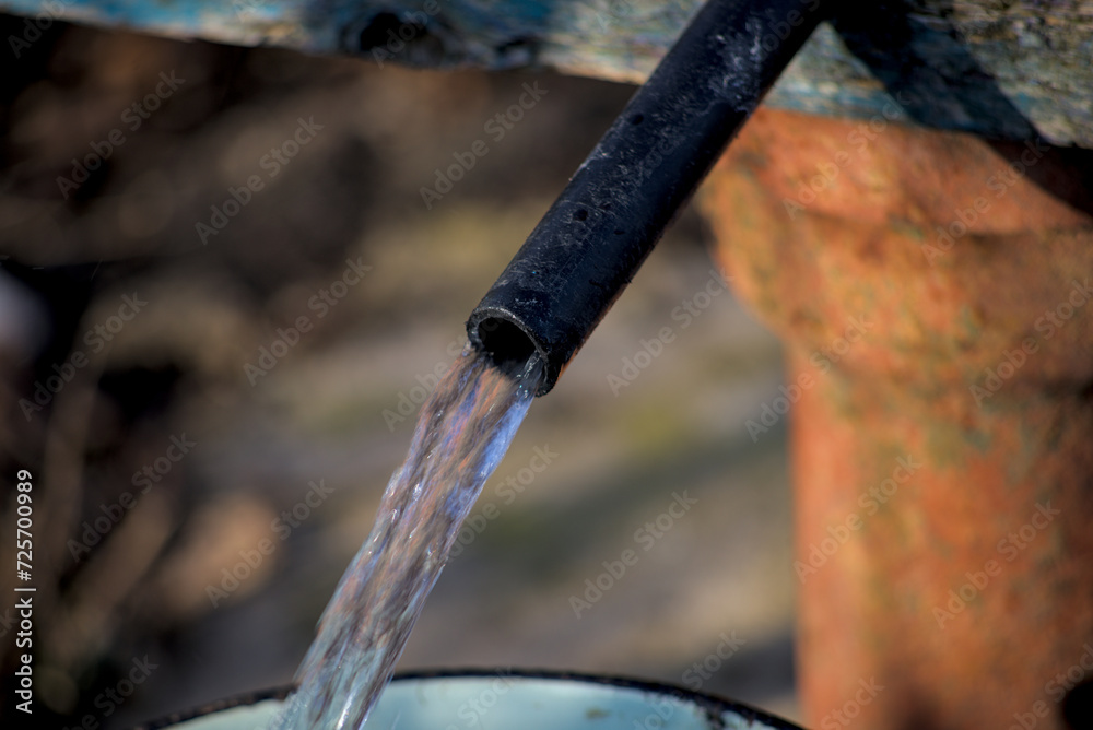 Clean water flows from a plastic pipe Clean water flows from a plastic pipe