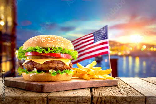 Burger mit Pommes, mit Skyline im Hintergrund und amerikanischer Flagge 
