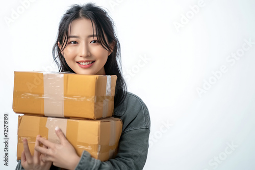 Happy Asian woman holding package parcel boxs isolated on white screen background with copy space, Delivery courier and shipping service concept..