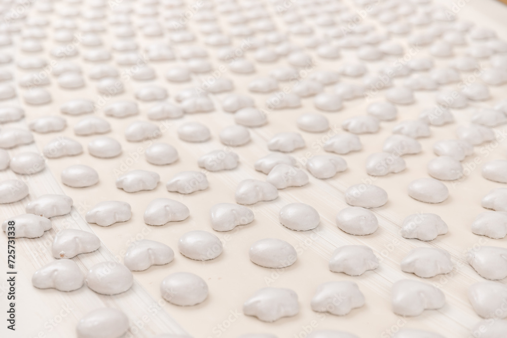 Conveyor line for production gingerbread cookies with white glaze at sweet factory. Modern plant for biscuit sugar cake. Conveyor line for production gingerbread cookies with white glaze at sweet factory. Modern plant for biscuit sugar cake.