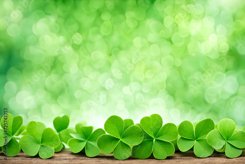 green bokeh background with green clovers in the foreground, st patrick day copyspace