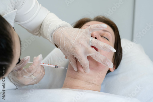 Focused on redefining jawline, lipolytics at work. Showcases the shift towards targeted facial sculpting treatments. photo