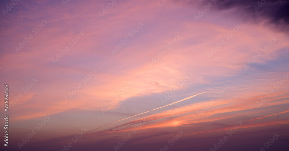 Pink blue sky background with clouds at sunset on a summer evening