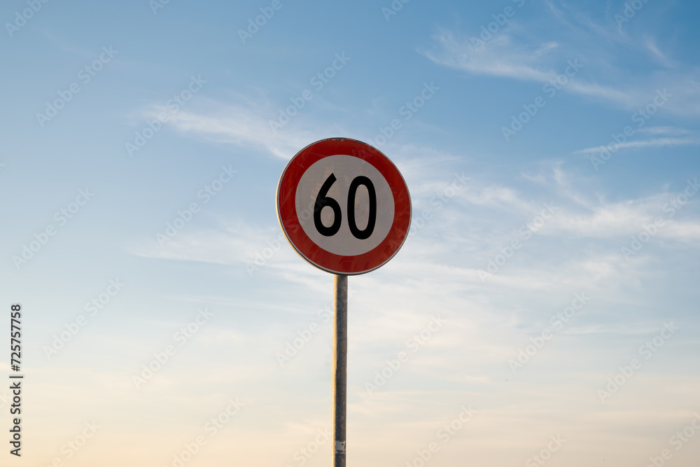 60 miles km maximum speed limit traffic sign isolated with sunset sky