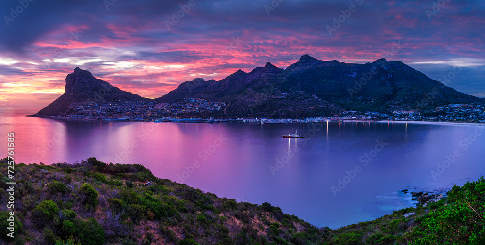 Fototapeta premium Panorama shot of Hout Bay and fishermans village at dusk with a colorful sky, Cape Town, South Africa