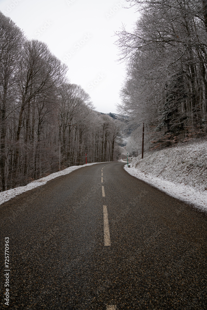 Road through the mountains and forest in the morning during the winter season, winter landscape in France Road through the mountains and forest in the morning during the winter season, winter landscape in France