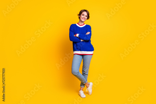 Full body photo of attractive young woman folded arms confident model wear trendy blue knitwear clothes isolated on yellow color background