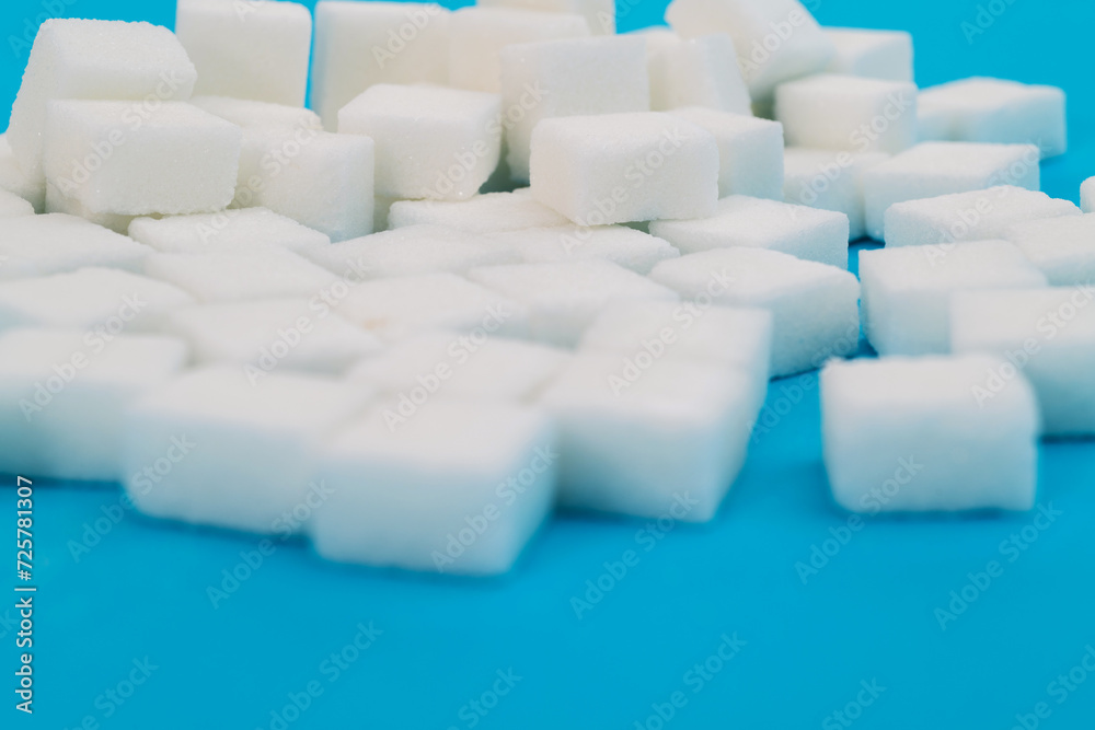Fototapeta premium Sugar cubes on blue background