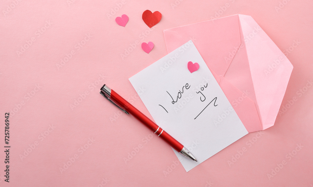 Romantic note on pink background with pink envelope and pen Romantic note on pink background with pink envelope and pen