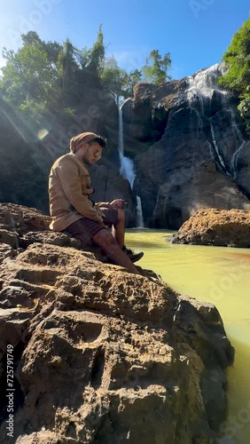 person on the waterfall Sukabumi, Indonesia photo