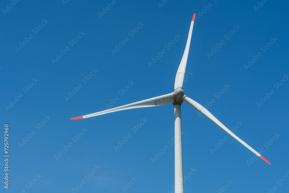 Wind turbine against blue sky with copy space Wind turbine against blue sky with copy space